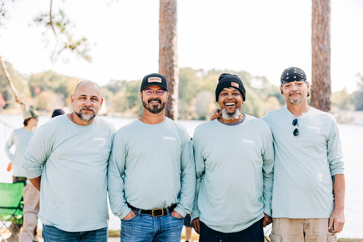 four men smiling for the camera